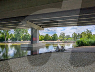 Young Couple Sitting By Stream In Shade