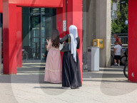 Women Standing At A Railway Station Entrance