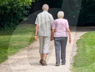 Senior Couple Walks Hand In Hand