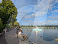 People Relaxing On The Shores Of Lake