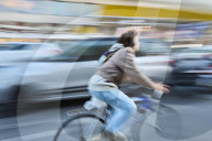 Urban Cyclist In Motion On A Busy City Street