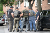 Members Of The United States Marshal Service Regional Fugitive Task Force Gather At The Scene Following The Arrest Of A 62-year-old Man Identified As Audwin Caines On West 142nd Street