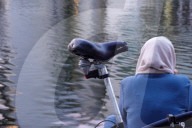 Woman Sitting Alone By The River In Berlin