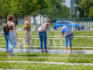 Tourists Cool Off At Fountain Near German Chancellery