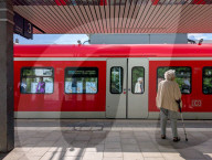 Senior Woman Waiting At A Suburban Train Station