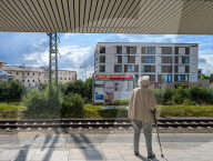 Senior Woman Waiting At A Suburban Train Station