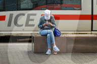 Young Woman Using Smartphone In Front Of ICE Train