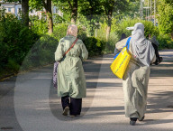 Women Walking By Lake Promenade In Summer