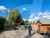 Women Walking By Lake Promenade In Summer