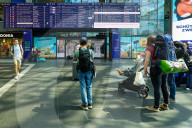 Travelers Check Train Departures At Berlin Main Station