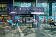 Travelers Check Train Departures At Berlin Main Station