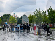 Young Travelers With Luggage Near Bundestag U-Bahn Station On Rainy Day