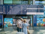 Travelers Check Train Departures At Berlin Main Station