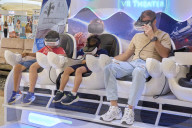 People Testing Virtual Reality Headsets In A Hypermarket