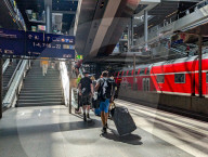 Berlin Main Station With Regional Train And Travelers
