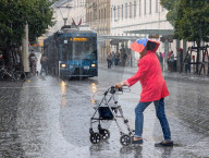 Senior Woman With Walker In Heavy Rain