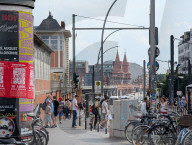 Berlin Traffic And Pedestrian Activity At Warschauer Strasse With View Of Oberbaum Bridge