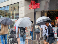 Shoppers In The Rain At A S.Oliver Store
