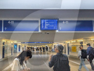 Traveler Checking Train Departures At Railway Station