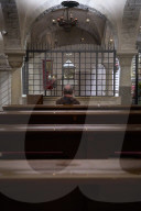Franciscan Friar Praying At The Tabernacle In The Crypt Of The Basilica Of Saint Nicholas In Bari