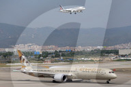Diverse aircraft on the takeoff runway at Barcelona Airport