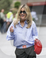 Pussycat Doll Ashley Roberts makes a stylish appearance at Heart radio wearing a blue shirt and trousers and red heels