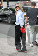 Pussycat Doll Ashley Roberts makes a stylish appearance at Heart radio wearing a blue shirt and trousers and red heels
