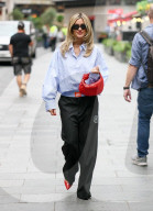 Pussycat Doll Ashley Roberts makes a stylish appearance at Heart radio wearing a blue shirt and trousers and red heels