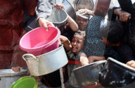 Palestinians Wait For Free Food From Food Distribution Center In Gaza City