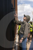DHS Secretary Kristi Noem visits border wall, paints it black