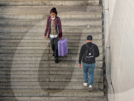 Woman With Suitcase And Man On Staircase