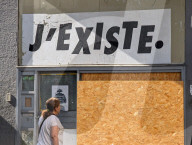 Woman Alone And Street Sign With The Text “I EXIST”
