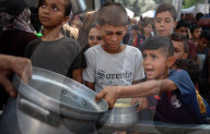 Palestinian Queue At Charity Kitchen In Central Gaza Strip