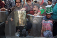 Palestinian Queue At Charity Kitchen In Central Gaza Strip