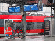 Passengers Wait In Heavy Rain At Nuremberg Central Station