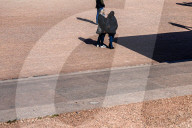 People Standing In Sunlight And Shadow