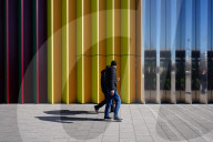 Men Walking Past Colorful Facade