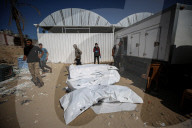 Gaza morgue workers recover bodies of Palestinians returned by Israel