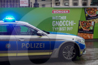 German Police Patrol Car Passes Burger Gnocchi Advertisement