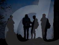 Dark Silhouettes Of Hikers On Rocky Peak