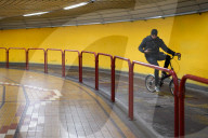 Cyclist Rides Through Underpass While Using Mobile Phone In Venice