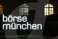 Illuminated Boerse Muenchen Signage At Stock Exchange Building At Night