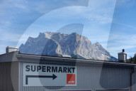 Zugspitze Mountain Peak Towering Over Supermarket Sign In The Tyrolean Alps