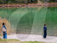 Family At Lake Mittersee Shore With Autumnal Forest Backdrop In Tyrol