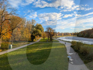 Walkers On Path Along The Isar River In Munich In Autumn