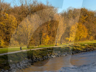 Walkers On Path Along The Isar River In Munich In Autumn