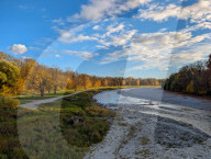 Wide View Of Isar River With Exposed Gravel Banks And Autumnal Foliage In Munich