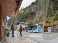 Passengers Wait At A Bus Stop In Biberwier In Tyrol With Alpine Backdrop