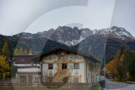 Tyrolean Village Houses And Autumn Foliage Against Zugspitze Massif Backdrop In Biberwier