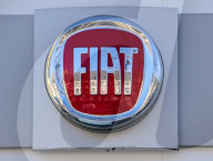 Close-up Of The Chrome Fiat Logo On A Dealership Building